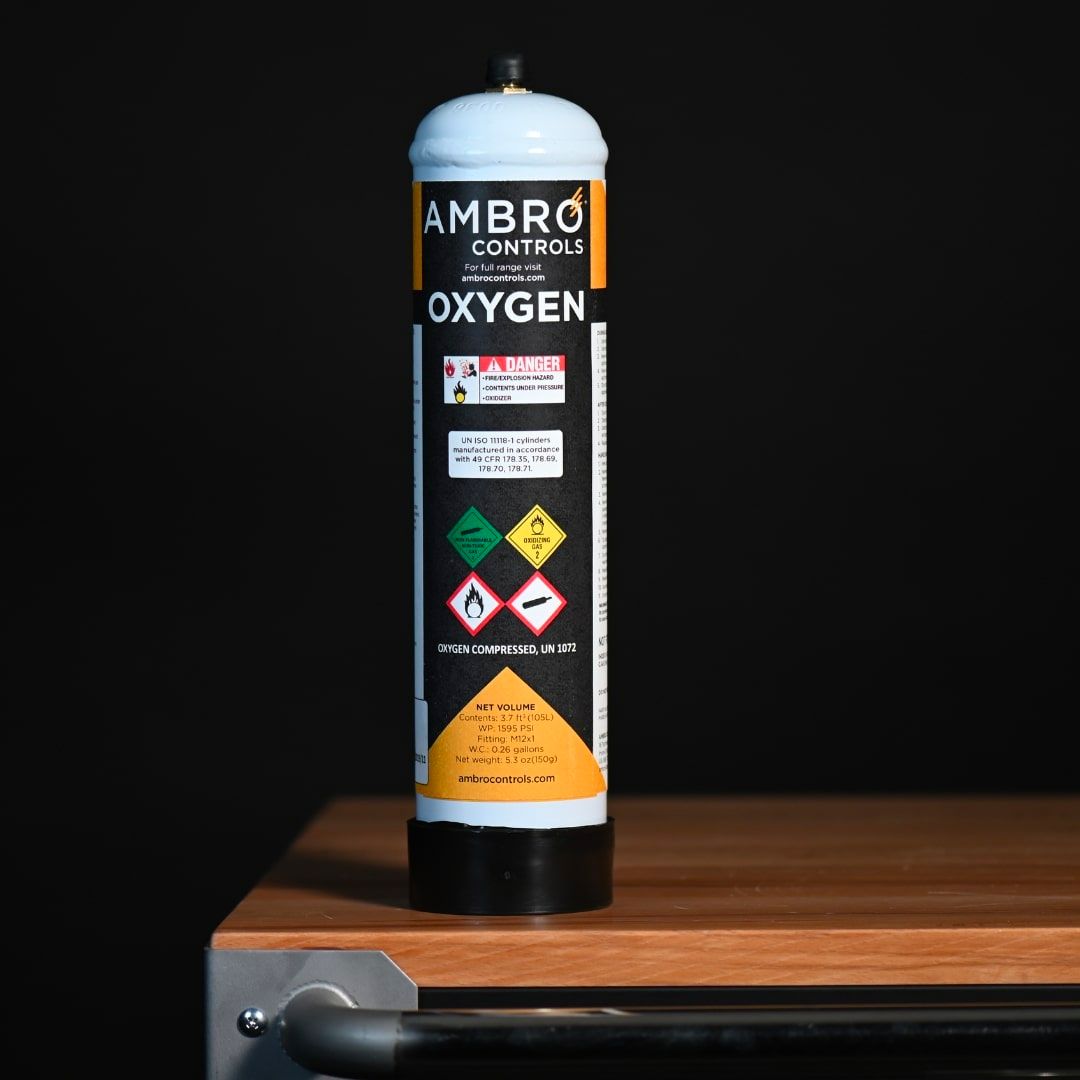 ambro oxygen cylinder sitting upright on a wooden table