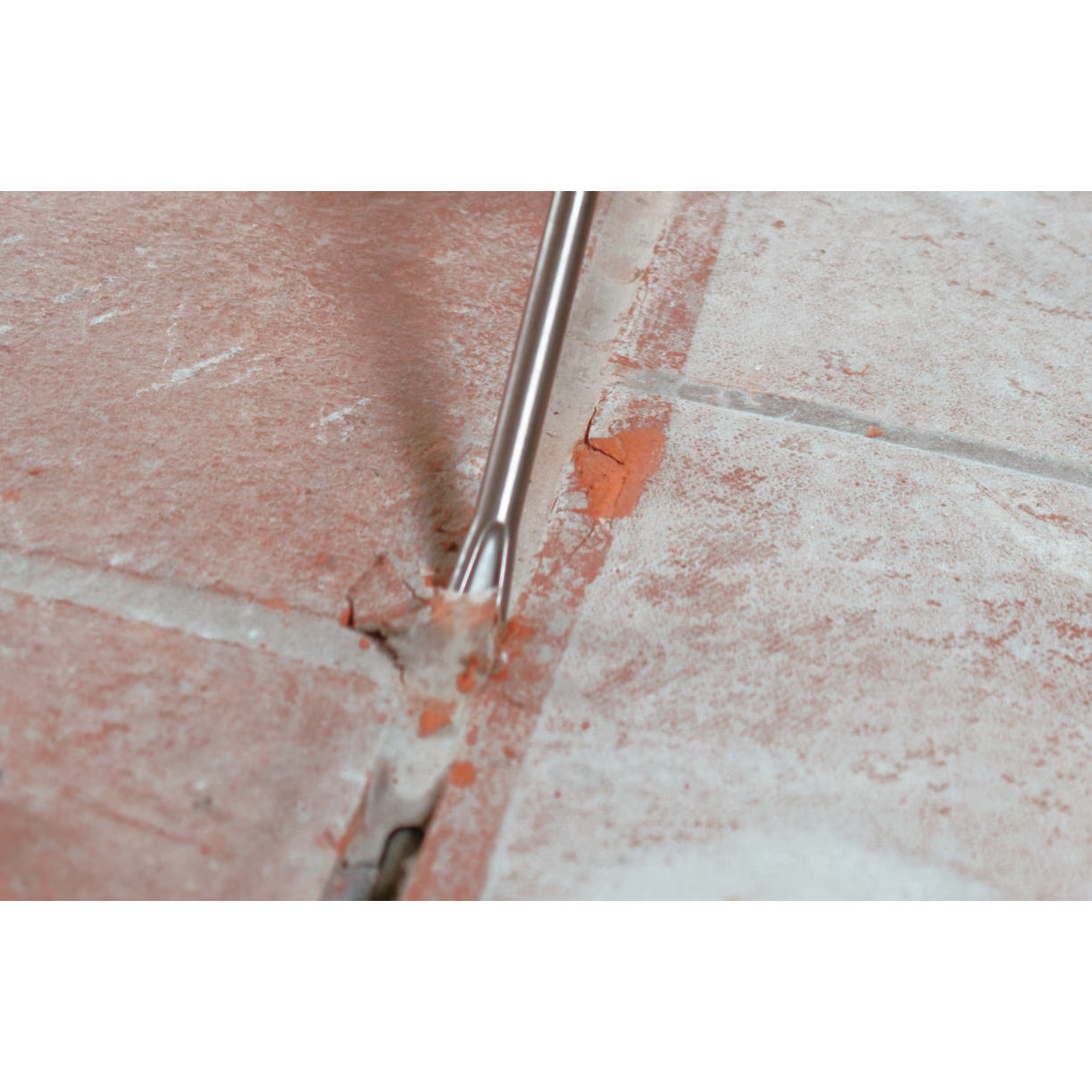 hilti hammer drill bit TE-CX FM 18 being used to remove grout between tiles