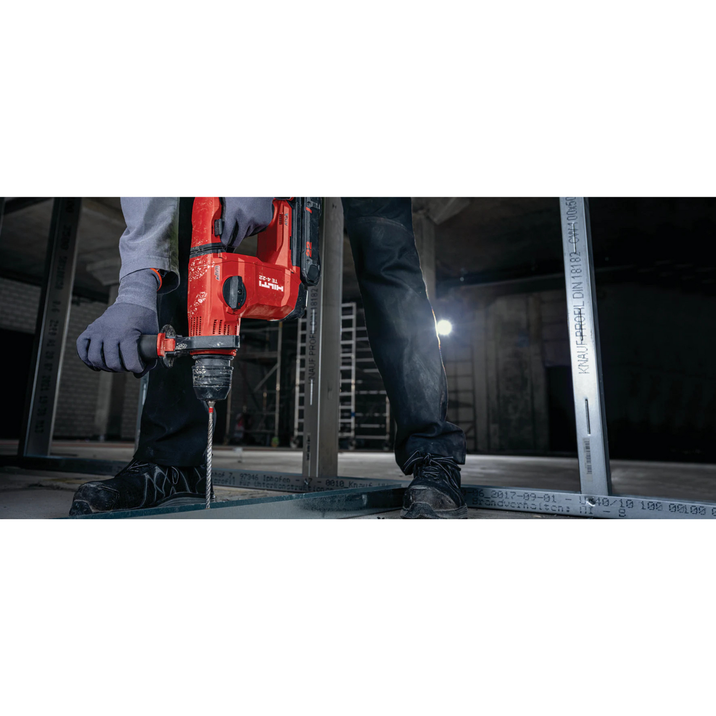 man using hilti masonry drill bit TE-CX 3/8" x 6" to drill hole through metal tracking on concrete floor