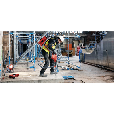 man applying hilti's hy 200-r anchoring adhesive into slab of concrete at construction sight