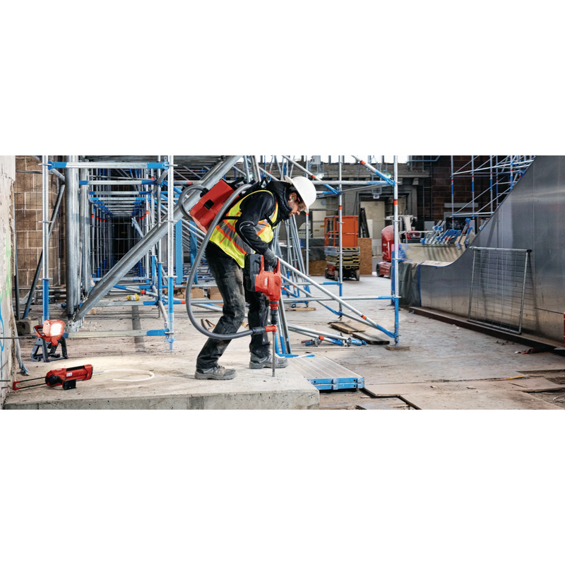 man applying hilti's hy 200-r anchoring adhesive into slab of concrete at construction sight