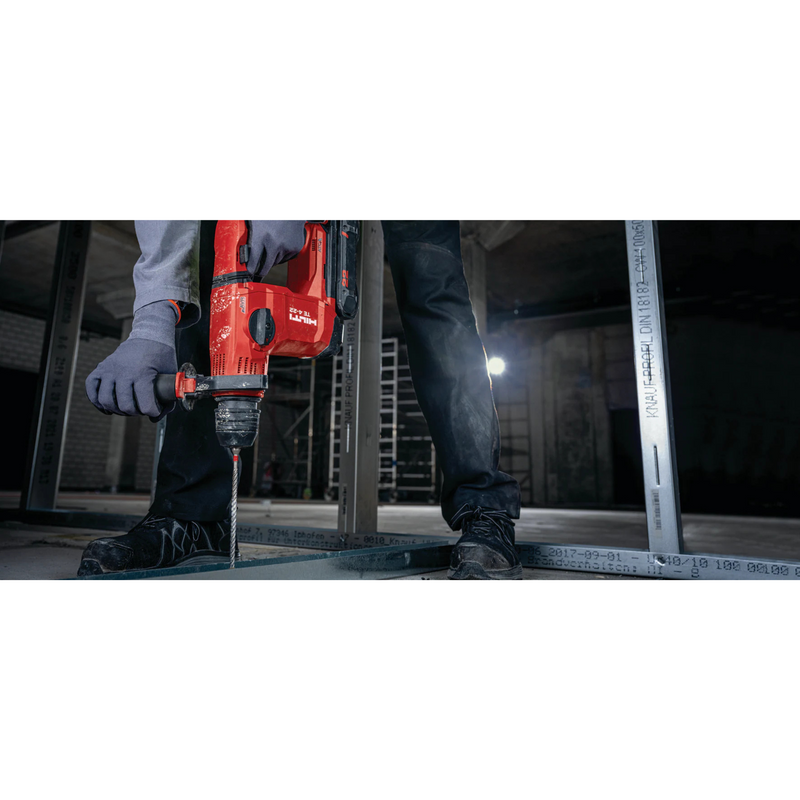 man using hilti masonry drill bit TE-CX 1/4" x 6" to drill hole through metal tracking on concrete floor
