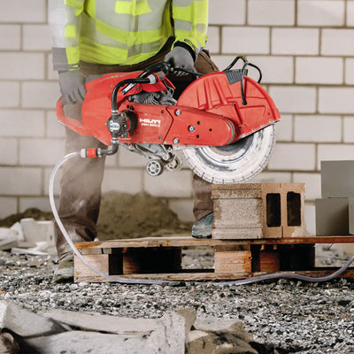 hilti's gas cut-off saw being used to cut a cinder block